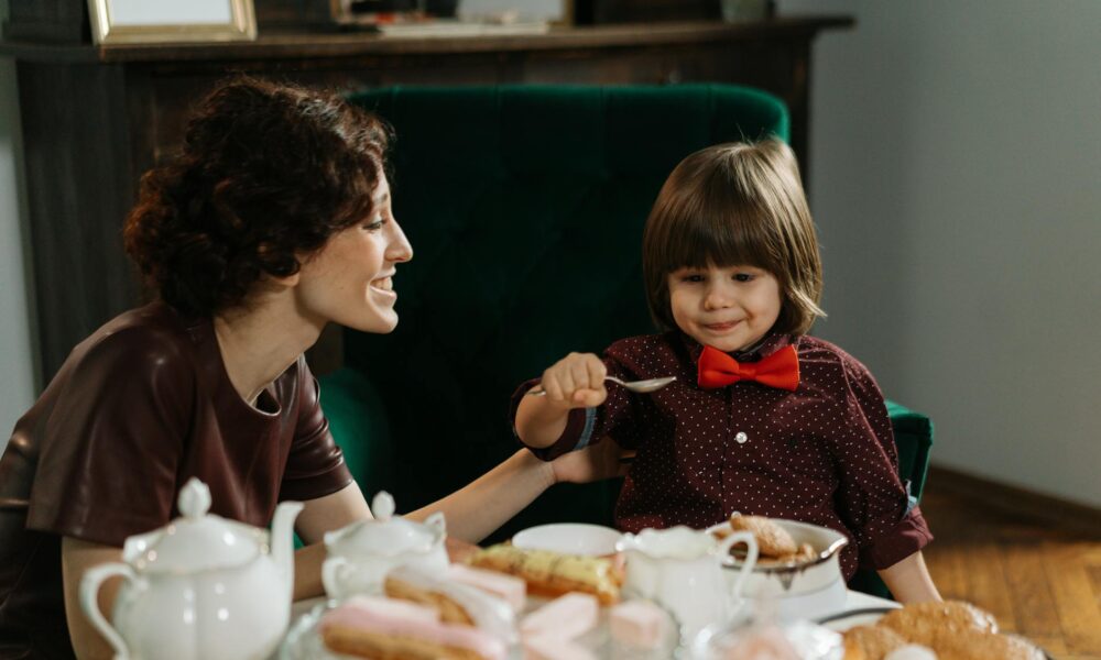 nanny and child sitting at the table